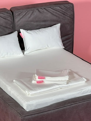 A Soho made up with its 400TC white bedding and two pillows, a spare set folded on top
